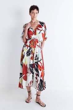 Say hello to sunny days with this one-of-a-kind dress, featuring a vibrant floral print and classic maxi silhouette. Style it heels or flats to dress up the look, or keep it more relaxed with sneakers or sandals. V-neckline Tie waist for adjustability Maxi length Side pockets *This item features an oversized fit. We recommend taking one size down in this style if a closer fit is preferred. Tropical Red Floral Print Maxi Dress, Tropical Red Maxi Dress With Floral Print, Red Tropical Print Maxi Dress For Spring, Spring Bold Print Maxi Dress, Summer Floral Print Maxi Dress For Daywear, Red Maxi Dress With Tropical Print For Spring, Chic Spring Maxi Dress With Bold Print, White Casual Maxi Dress With Vibrant Print, Casual White Maxi Dress With Vibrant Print