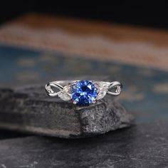 Lab Sapphire Engagement ring White Gold September Birthstone Marquise Moissanite Leaf Floral Flower Split Shank Bridal Anniversary WomenSimilar Design:https://www.etsy.com/listing/527392974https://www.etsy.com/listing/541192467https://www.etsy.com/listing/527395084ITEM INFORMATIONMetal Type – Solid 14k Rose GoldBand Width – (approx. 1.25mm)Center Stone – 7mm Lab Sapphire, Round CutSide Stone – MoissaniteWeight – 0.25ctShaped – Marquise Cut**Stone Replacement**Available with any other gemstones, Fine Jewelry Sapphire Three Stone, Elegant Cubic Zirconia Gemstones For Wedding, Three Stone Diamond Gemstones For Anniversary, Wedding Jewelry With Sapphire And Diamond Accents, Three Stone Moissanite Jewelry For Anniversary, Anniversary Three Stone Moissanite Jewelry, Blue Fusion Style Jewelry For Wedding, Blue Fusion Style Wedding Jewelry, Wedding Cubic Zirconia Gemstones