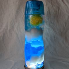 a blue vase filled with water and clouds