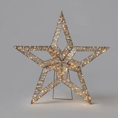 a lighted christmas star on a stand