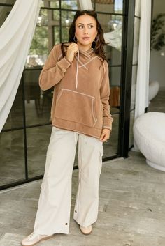 The Camden Brown Hoodie Sweatshirt is your go-to for effortless style and comfort. Made from lightweight camel brown fabric, this hoodie features subtle white stitch detailing for a modern look. The attached hoodie with adjustable drawstring ties offers a classic casual vibe, while the front pocket provides extra practicality. Side slits and long sleeves add ease of movement, making the Camden sweatshirt perfect for layering or wearing on its own for a laid-back yet polished outfit. Camden Sweatshirt, Best Shirt, Brown Hoodie, White Bodycon Dress, Travel Dress, Classic Casual, Brown Fabric, Jumpsuit Shorts Rompers, Maxi Dresses Casual