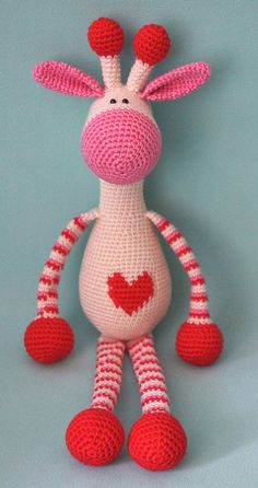 a crocheted giraffe with hearts on it's legs