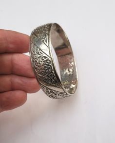 Vintage Berber cuff bracelet in silver with floral motifs - Essaouira - Morocco  Early 20th century,  Inner diameter: 6.3 cm (2.36 inches) Width: 1.9 cm (0.75 inche) Circumference (wrist circumference): 19.78 cm (7.50 inches ) Total weight: 68.10 grams Feel free to contact me for any question about this item, I will be happy to answer you as soon as possible. Visit my Etsy Shop: https://www.etsy.com/fr/shop/TIFINAGH Réf : 18 / B2 Traditional Silver Round Cuff Bracelet, Traditional Sterling Silver Cuff Bracelet For Weddings, Festive Silver Bracelet With Intricate Design, Traditional Ceremonial Bangle With Filigree, Ornate Silver Hallmarked Bangle, Antique Silver Wedding Bangle With Intricate Design, Wedding Antique Silver Bangle With Intricate Design, Traditional Filigree Bracelets For Ceremonial Use, Antique Silver Cuff Bracelet With Intricate Design For Wedding