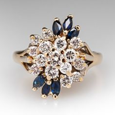 The sophisticated cluster ring is accented with fifteen (15) prong set, round brilliant cut diamonds and six (6) prong set, marquise cut natural sapphires. The ring measures 18.6mm at the top, rises 9.8mm above the finger, tapering to 2.1mm wide and 1.2mm thick at the base of the shank. Several of the diamonds are lightly chipped but nothing that can be seen without magnification. It is currently a size 6. Timeless Cluster Ring With Prong Setting, Diamond Cluster Sapphire Anniversary Ring, Cluster Diamond Sapphire Anniversary Ring, Cluster Sapphire Diamond Ring For Anniversary, Anniversary Cluster Multi-stone Diamond Ring, Anniversary Multi-stone Cluster Diamond Ring, Heirloom Style Cubic Zirconia Cluster Ring, Marquise Cluster Ring With Prong Setting In Cubic Zirconia, Cluster Sapphire Ring For Anniversary