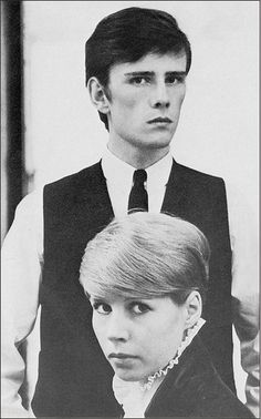 an old photo of two people in formal wear, one is looking at the camera