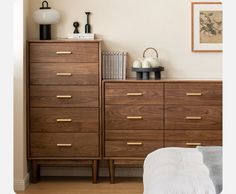 a bedroom scene with focus on the chest of drawers and nightstands in the foreground