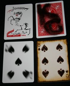 four playing cards with different designs on them