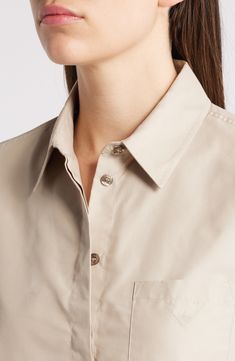 A cropped silhouette balanced by a slightly boxy fit enhances the breezy look of this button-up shirt cut from smooth poplin. Hidden-button placket Point collar Long sleeves with button cuffs Chest patch pocket 53% cotton, 47% polyester Dry clean Imported Classic Cropped Button-up Shirt With Button Cuffs, Classic Relaxed Fit Button-up Cropped Shirt, Elegant Button-up Cropped Shirt For Work, Classic Button-up Cropped Shirt For Work, Workwear Cropped Shirt With Button Cuffs, Button-up Cropped Shirt With Button Cuffs For Work, Modern Collared Cropped Shirt For Work, Relaxed Fit Cropped Shirt With Buttons For Work, Chic Cropped Shirt With Button Cuffs For Work