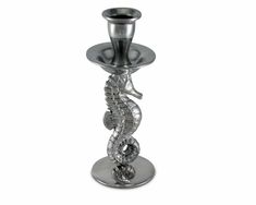 a silver candle holder with a seahorse on it