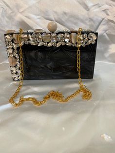 - Tich lock closure  - Golden chain inside - Removable sling chain This clutch can be worn as a shoulder bag with the sling chain or can simply be carried in hand.It is spacious enough to carry mobile phones, lipsticks, Keys and other small accessories.It comes in dust cover placed in a corrugated box. Designer Square Clutch As A Gift, Designer Square Clutch As Gift, Designer Rectangular Box Bag For Evening, Pearl Handle Clutch Box Bag As Gift, Elegant Square Box Bag, Designer Clutch Box Bag For Gift, Square Evening Bag With Pearl Handle As Gift, Square Clutch With Chain Strap As Gift, Designer Gift Clutch Box Bag