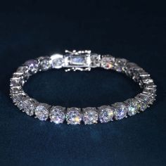 This ICECARTEL exclusive Moissanite Tennis Bracelet is made from 925 sterling silver and PVD plated with a thick layer of 14K Gold. This moissanite tennis bracelet is iced out with round cut, colorless (D-Color), VVS moissanite flawless diamonds, placed in a prong diamond setting. All of the diamonds on this moissanite tennis chain are guaranteed to pass the diamond tester. This moissanite tennis bracelet features an extremely durable lobster clasp, which is specially designed to never break or Luxury Iced Out Sterling Silver Bracelet, Dazzling Silver Moissanite Bracelets, Elegant Iced Out Round Diamond Bracelet, Elegant Round Iced Out Diamond Bracelet, Wedding Cubic Zirconia Iced Out Bracelets, Elegant Iced Out Bracelets, Elegant Iced Out Round Bracelets, Elegant Iced Out Sterling Silver Bracelet, Elegant Iced Out Sterling Silver Bracelet With Cubic Zirconia