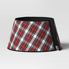 a red and white plaid lampshade with black trim on the bottom, in front of a gray background