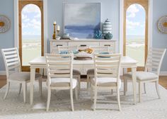 a dining room with blue walls and white furniture