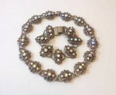 "~ 1950s Baroque style rhinestone jewelry set ~ Intricately designed ovals with a rhinestone centers ~ Chunky choker necklace & matching bracelet ~ Bronze tone metal ~ Excellent set No Mark or Signature Necklace- 17\" (43 cm) Bracelet- 7.75\" (19.75 cm) More Fantastic Vintage Jewelry: glennasvintageshop.etsy.com Additional Vintage in our sister shop Glenna's Jewels: glennasjewels.etsy.com Instagram @glennas_clothing Facebook https://www.facebook.com/glennasclothing" Vintage Oval Rhinestone Jewelry, Baroque Necklace, Chunky Choker Necklace, Rhinestone Jewelry Set, Chunky Choker, Signature Necklace, Tacoma Wa, Baroque Style, Matching Bracelet