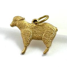 COSTUME JEWELRY CHARM ITEM DESCRIPTION This listing is for a brass charm of a cute little sheep. Ba ba brass sheep!  Small in size but has nice detail.  Wear as a bracelet charm or as a dainty necklace pendant. Slightly convex on the back side. Never used. The charm has vintage style however is more recently made form a vintage stamp. Any minor flaws or patina from age / storage only. Quarter and ruler in photo for size reference. Brass will develop a patina over time. Exposure to lotions, perfu Dog Lover Jewelry, Brass Charms, Vintage Stamps, Dainty Necklace, Etsy Jewelry, Jewelry Lover, Charm Jewelry, Charm Pendant, Sheep