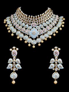 "Gulrukh Meenakari Bridal Set - Pastel Blue A pure hand-drawn detailed jewelry in the shades of soft pink and green meenakari work. This piece displays high-quality workmanship and fine usage of stones! This meenakari necklace set is perfect for western or traditional outfits. This set features a necklace with jadai detailing, featuring kundan chand motifs with lotus meenakari detailing. Delicate necklace accented with kundan stones and faux pearls creating a lush, sparkling set. The set include Traditional Blue Bridal Necklace For Formal Occasions, Round Temple Jewelry With Motifs, Temple Jewelry With Round Motifs, Elegant Enamel Jewelry With Meenakari, Meenakari Enamel Jewelry, White Meenakari Jewelry For Diwali, Ceremonial Meenakari Enamel Jewelry, Temple Jewelry With Motifs For Diwali, White Meenakari Temple Jewelry