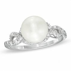 A masterpiece of design and elegance, this pearl and diamond ring will take her breath away. Expertly crafted in sleek sterling silver, this ring captivates with a stunning 8.5-9.0mm cultured freshwater pearl at its center. Ribbons of shimmering diamonds surround the center stone and create the cleverly twisting shank. Radiant with 1/10 ct. t.w. of diamonds, this ring is finished with a bright polish. Custom made to fit her ring size. Sterling silver rings cannot be resized after purchase. Silver Rings With Diamond Accents And Pearl, Silver Pearl Rings With Diamond Accents, Pearl White Diamond Pearl Ring With Accents, Pearl White Diamond Pearl Ring With Diamond Accents, Diamond White Pearl Ring With Diamond Accents For Promise, Pearl White Pearl Ring With Diamond Accents, Elegant Diamond Pearl Promise Ring, Elegant Diamond Pearl Ring For Promise, White Pearl Rings With Diamond Accents