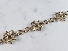 "A WOMEN'S VINTAGE ESTATE 14K YELLOW GOLD FLOWER BRACELET THAT WAS MADE IN ITALY. THE BRACELET MEASURES 7 1/2\" LONG BY ABOUT 7/8\" WIDE, AND WEIGHS 9.9g. THIS WOULD MAKE A LOVELY GIFT AND IS A GREAT VALUE FOR THE MONEY. IF ANY OTHER QUESTIONS, PLEASE ASK. BE SURE TO CHECK OUT SOME OF MY OTHER GREAT ITEMS UP FOR SALE. THANK YOU" Formal Yellow Gold Flower Bracelet, Formal Yellow Gold Costume Jewelry Bracelet, Estate Jewelry Gold Stamped 14k, Gold Estate Jewelry Stamped 14k, Estate Style 14k Stamped Gold Jewelry, Gold Flower Bracelet, Italian Bracelet, Bridal Gold Jewellery, Gold Flower