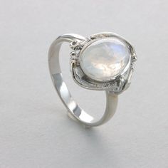 This is a beautiful Rainbow Moonstone Ring in 925 Sterling Silver with a Rhodium finish.  The silver does also not include any nickel or other substances causing most allergies. The ring is thus hypoallergenic. Rhodium makes the silver less tarnish. Size of the Moonstone 1.1 x 0.8 cm 0.43 x 0.31 inch Please note: Our jewelry is photographed close up to show detail and may appear larger than they are. We use a dime coin as size reference on one of the pictures. Usually we ship on the same day we receive the payment for the order. You will receive the item in a gift box - perfect to surprise someone or yourself. We want you to be happy with your purchase. If you do not like what you bough can send it back and we will refund you the money. Please do not hesitate to contact us so we can solve White Moonstone Promise Ring With Polished Finish, White Moonstone Ring With Polished Finish For Promise, Polished Moonstone Wedding Ring, Wedding Moonstone Ring With Polished Finish, Sterling Silver Moonstone Ring With Polished Finish For Promise, Adjustable White Gold Moonstone Ring, Silver Sterling Silver Moon-shaped Opal Ring, Silver Moon-shaped Sterling Silver Opal Ring, Silver Sterling Silver Moon Shaped Opal Ring