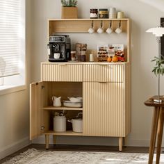 a kitchen with a wooden cabinet and coffee maker on the top shelf next to a window