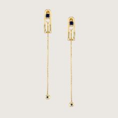 An impressive and special earring with a design element in the form of a vertical clasp inspired by the world of tailoring that characterizes the TAILORED collection. The top of the element is studded with a 3 mm Sapphire that gives the earring a powerful look without detracting from its delicacy. A delicate chain with a Sapphire studded gold ball at the end, threaded from the bottom of the earring, adds an elegant sway to this special piece. The earring is inspired by the buttons and cuffs that make up the female suit and is part of the TAILORED collection The earrings are sold as singles All features can be customized! Please contact us if you wish to make changes, we love making custom designs. All of our jewelry is carefully handmade in our atelier. *HC diamond are all conflict-free di Multi Sapphire Earrings, Luxury Sapphire Earrings With Polished Finish, Elegant Sapphire Earrings (lab-created), Luxury Polished Sapphire Earrings, Luxury Multi-stone Sapphire Earrings, Sapphire Studs, 18k Rose Gold, Conflict Free Diamonds, Design Element