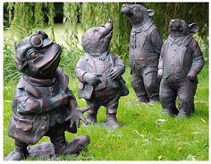 three statues of mice are in the grass