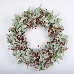 a christmas wreath with red berries and green leaves on a white background, ready to be used as an ornament