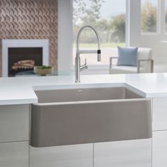 a kitchen sink sitting on top of a counter next to a fire place in a living room