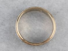 Polished two-tone gold provides a beautiful weight upon the hand in this vintage wedding band. The minimalist style and milgrain edged creates a sophisticated style upon the hand! Metal: 14K White and Yellow Gold Width of Band: 4.4 mm Height off Finger: 1.6 mm Ring Size: 6 Marks: "14K" Stamped on the inside band Vintage Wedding Band, Gold Band, Minimalist Style, Sophisticated Style, Gold Bands, Vintage Wedding, Minimalist Fashion, Wedding Band, Two Tone