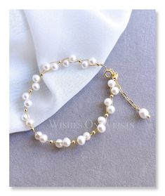 a bracelet with white pearls on it