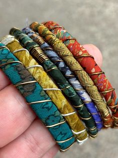 Stack up on these colorful & bold boho bangles!  I wrap each bracelet by hand with unique upcycled sari silk and finish with a wire wrap to secure.  Add vintage kuchi coin charms to a few or all to complete the look, These bracelets are a super simple and lightweight for easy, comfortable wear. Select one or mix and match to create your own personalized set! ★ Handmade ★ Upcycled Sari Silk ★ Non-Tarnish Wire ★ Vintage Kuchi Coin Charm ★ 65mm inner diameter ✉ Message for Custom Requests ✈ Free Sh Bohemian Hand Wrapped Multicolor Bracelets, Bohemian Multicolor Hand Wrapped Bracelets, Artisan Multicolor Wrap Bracelet For Festival, Multicolor Hand Wrapped Wrap Bracelet For Festival, Artisan Adjustable Bangle For Festivals, Multicolor Hand Wrapped Bangle Bracelets, Multicolor Hand Wrapped Bangle Bracelet, Multicolor Bangle Wrap Bracelet For Festival, Multicolor Bohemian Bracelets For Festivals