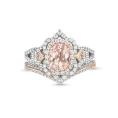 a pink diamond ring set with diamonds on the band and an oval shaped center stone