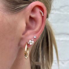 Add some sparkle to your ear with this dainty diamond stud! Dainty Everyday Diamond Piercings, Dainty Diamond Piercings For Everyday, Elegant Tiny Cartilage Earrings For Anniversary, Dainty Yellow Gold Piercings With Single Diamond, Elegant Rose Gold Cubic Zirconia Piercings, Elegant Rose Gold Piercings With Cubic Zirconia, Elegant Rose Gold Huggie Piercings, Dainty Diamond Wedding Piercings, Elegant 14k Gold Cartilage Earrings With Diamond Accents