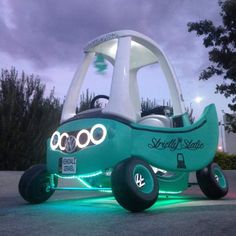 an electric car with wheels and lights on it