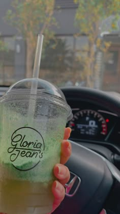 a person holding up a drink in their hand with the words glorie team's on it