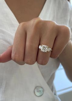 a woman's hand with a ring on it and the middle finger pointing towards the camera