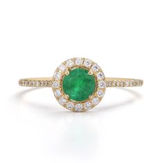 Emerald Engagement Ring May Birthstone Diamond Ring With Halo, May Birthstone Halo Diamond Ring, Emerald Diamond Halo Ring With Round Cut, Emerald Ring With Diamond Halo Design, Luxury Round Diamond Ring For May Birthstone, Emerald Halo Diamond Ring Round Cut, Green Cluster Ring With Halo, Emerald Ring With Halo For May Birthstone, May Birthstone Round Brilliant Cut Diamond Ring