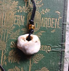 Hag Stone Pendant Pendulum Cord Necklace Witch Stone, Odin Stone This is a flint hag stone which has been eroded over time to give the hole in the centre.  Throughout many cultures these naturally eroded stones have been held as magical stones. Length of the cord and stone is 45cm long and has a slip know fastening. The stone measures approx 3.5cm x 3cm approx The cord is made from cotton and can be adjusted by the slip knot. Can be used as a pendulum also. The bead is a glass bead. Blessings fr Spiritual Pendant Necklace With Adjustable Cord, Spiritual Pendant Jewelry With Adjustable Cord, Spiritual Necklace With Adjustable Cord, Adjustable Bohemian Necklaces For Collectors, Hand Cast Bohemian Necklace As Gift, Bohemian Hand Cast Healing Jewelry, Bohemian Healing Jewelry Hand Cast, Adjustable Hand Cast Round Pendant Necklaces, Bohemian Hand Cast Necklace For Gift