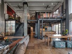 an industrial loft with exposed brick walls and wood flooring is pictured in this image