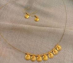 Gold plated traditional coin necklace with Lakshmi print. Necklace is made with green, red stones. Comes with matching earrings. Perfect for any festive occasions. These Beautiful Gold Platted Necklace Best for gifting and personal use, You can gift your Girlfriend, Mother, Sister, Relatives, Neighbors etc. Combine it with Matching Dress and be the Limelight of every Occasion (Diwali, Birthday, Anniversary, Christmas, Any Ritual Festival). Suitable for all occasions. The strong is so thin that it could almost appear as invisible and make it look like a beautiful set of coins dangling on your neck. Kasu Mala, Invisible String, Red Stones, Coin Necklace, Red Stone, Matching Dresses, Birthday Anniversary, Matching Earrings, Diwali