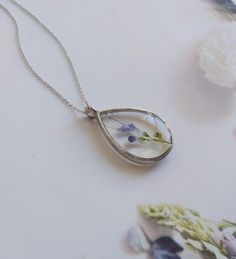 "Real flower necklace, woodland necklace, terrarium necklace, botanical necklace, real flower pendant, pressed flower necklace, resin finding These unique handcrafted necklaces are designed specifically for you! Made with natural flowers from the wild, this necklace is dainty, lightweight and it makes a perfect statement. Every VBRTN item is handmade with care in my Denver, CO studio. As someone that has passion for creating timeless healing pieces that you will fall in love with, I strive to tr Nature-inspired Birth Flower Necklace As A Gift For Her, Sterling Silver Necklace With Natural Inclusions For Gift, Bohemian Necklace With Birth Flower Round Pendant, Bohemian Birth Flower Round Pendant, Minimalist Sterling Silver Necklace With Pressed Flowers, Botanical Jewelry With Pressed Flowers, Sterling Silver Necklaces With Pressed Flowers, Sterling Silver Flower Jewelry For Keepsake, Sterling Silver Flower Jewelry Keepsake