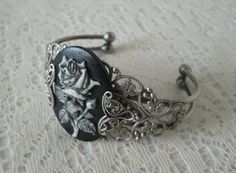 This beautiful silver plated filigree cuff bracelet has a rose cameo setting with silver plated filigree accents on the sides. Adjustable. Gothic Nickel-free Jewelry For Weddings, Gothic Nickel-free Wedding Jewelry, Gothic Silver Bracelet, Silver Gothic Bangle, Handmade Antique Silver Gothic Jewelry, Handmade Gothic Antique Silver Jewelry, Adjustable Victorian Cuff Bracelet For Formal Occasions, Filigree Metal Cuff Bracelet Gift, Metal Filigree Cuff Bracelet Gift