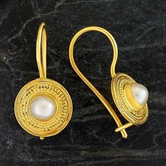 Handcrafted of a tiny disc of filigree thread, this classic Greek design which highlights the beauty of single pearls are subtle yet undeniably brilliant. 24k gold over sterling silver; hinged backs. Size: 7/8 Inches. Gold Pearl Earrings 22k As Gift, Gold Sterling Silver Pearl Earrings, Gold Sterling Silver Round Pearl Earrings, Gift 22k Gold Jewelry With Pearl Drop, Delicate Gold Plated Round Pearl Earrings, Gold Pearl Drop Earrings In 22k, Handmade Classic Yellow Gold Pearl Earrings, Classic Handmade Yellow Gold Pearl Earrings, Classic Adjustable Gold Pearl Earrings