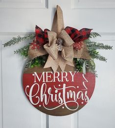 a merry christmas door hanger on the side of a white door with red and black plaid ribbon