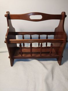 an old wooden rack with two racks on it's sides and one shelf for storing items