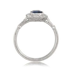 This stunning sapphire ring centers a 1.48 carat sapphire bezel set in handcrafted platinum. Surrounding the center gem is a halo of lively diamonds. This ring is further adorned by a stunning openwork filigree under-gallery and fine milgrain. ✦ DIAMOND SPECIFICATIONS: Diamond Cut: Emerald Cut Diamond Weight 1.48 Carats ✦ ENGAGEMENT RING SPECIFICATIONS: Ring Material: Platinum Stones: Diamond, Sapphire ✦ WHAT COMES IN YOUR SHIPMENT: - Your Engagement Ring - Quality Ring Box - Jewelry Cleaner - U Gia Certified Cushion Cut Sapphire Ring In Platinum, Classic Gia Certified Sapphire Ring, Classic Sapphire Ring With Lab-created Gemstone, Timeless Sapphire Ring With Bezel Setting, Elegant Baguette Cut Sapphire Ring With Bezel Setting, Classic Sapphire Ring With Round Cut, Anniversary Sapphire Ring In Cushion Cut Platinum, Formal Asscher Cut Sapphire Ring With Center Stone, Heirloom Sapphire Ring With Baguette Cut