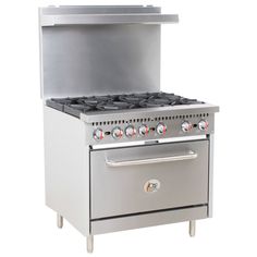 a silver stove top oven sitting next to a white wall