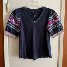 Size Small Nwt Anthropologie Embroidered Top. Sleeves Have Embroidered Details. Casual Embroidered Short Sleeve Top, Blue Cotton Embroidered V-neck Top, Navy Embroidered Cotton Tops, Blue Cotton Top With Geometric Embroidery, Blue Cotton Top With Embroidered Sleeves, Blue Cotton Top With Embroidered Hem, Blue Cotton Embroidered Hem Top, Blue Cotton Embroidered Top With Embroidered Hem, Blue Cotton Embroidered Top With Hem Detail