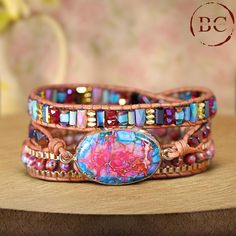 This popular jewelry piece features a Natural Stone Pink Jaspers Beaded Leather Wrap Bracelet, designed for a distinctive boho flair. The bracelet showcases beautifully strung pink jasper beads, known for their vibrant hues, wrapped around a supple leather strap. With its triple-layered design, it offers a bold and stylish statement, perfect for adding a touch of elegance to any outfit. Ideal for women who appreciate both bohemian style and natural beauty and makes for a thoughtful friendship gi Bohemian Brown Crystal Bracelet With Gemstone Beads, Brown Gemstone Beads Crystal Bracelet In Bohemian Style, Bohemian Gemstone Beads Wrap Bracelet For Festivals, Bohemian Wrap Bracelet With Gemstone Beads For Festivals, Adjustable Brown Bohemian Crystal Bracelet, Multicolor Beaded Spiritual Leather Bracelet, Bohemian Adjustable Leather Bracelet With Colorful Beads, Bohemian Gemstone Beaded Bracelets, Adjustable Bohemian Leather Bracelet With Colorful Beads