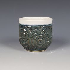 a ceramic cup sitting on top of a table